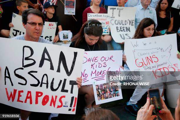 Protesters hold signs at a rally for gun control at the Broward County Federal Courthouse in Fort Lauderdale, Florida on February 17, 2018. Seventeen...