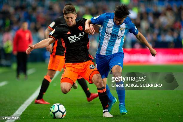 Valencia's Argentinian forward Luciano Vietto vies with Malaga's Argentinian midfielder Gonzalo Castro "Chory" during the Spanish league football...