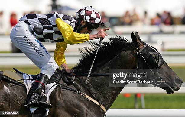 Brad Rawiller gestures after riding Viewed to win the BMW Caulfield Cup during the Caulfield Cup Day meeting at Caulfield Racecourse on October 17,...