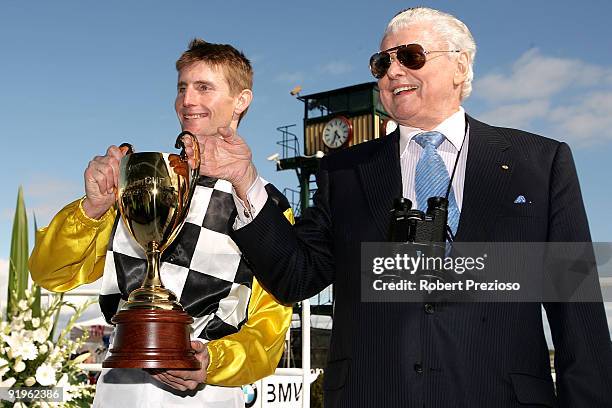 Trainer Bart Cummings with Jockey Brad Rawiller holding the winners cup after winning the BMW Caulfield Cup during the Caulfield Cup Day meeting at...
