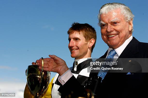 Brad Rawiller and Bart Cummings celebrates with the cup after their horse Viewed won the Caulfield Cup during the Caulfield Cup Day meeting at...