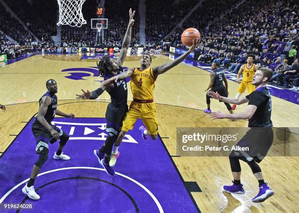 Donovan Jackson of the Iowa State Cyclones drives to the basket against Cartier Diarra of the Kansas State Wildcats during the second half on...