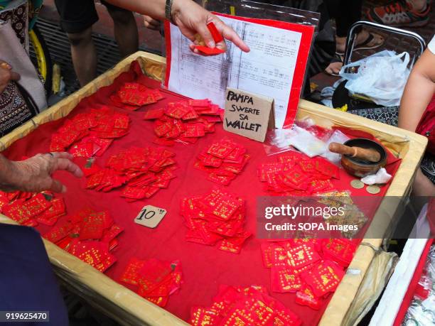 Vendors selling chinese red envelopes in the streets of Binondo. Filipinos celebrated the Chinese New year by visiting chinatown in Binondo to enjoy...