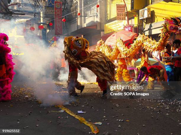 Lit fireworks during the traditional dragon dance in the streets of chinatown in binondo. Filipinos celebrated the Chinese New year by visiting...