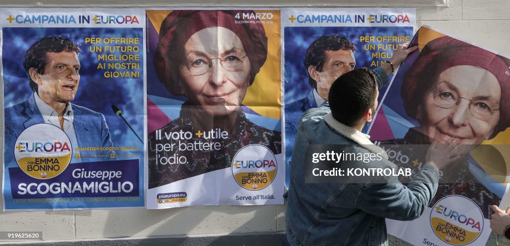 Volunteers attach banner of Emma Bonino, member of the...