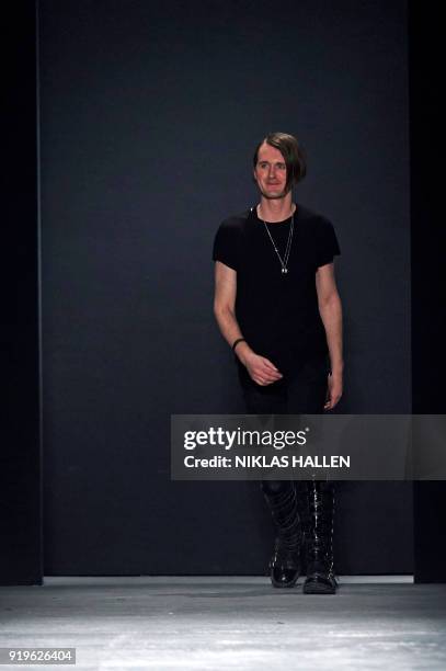 British designer Gareth Pugh greets the audience after his catwalk show on the second day of London Fashion Week Autumn/Winter 2018 in London on...