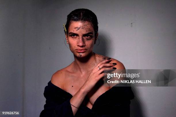 Model is prepared ahead of the catwalk show by British designer Gareth Pugh on the second day of London Fashion Week Autumn/Winter 2018 in London on...