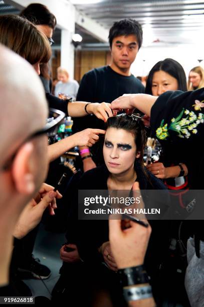 Model is prepared ahead of the catwalk show by British designer Gareth Pugh on the second day of London Fashion Week Autumn/Winter 2018 in London on...