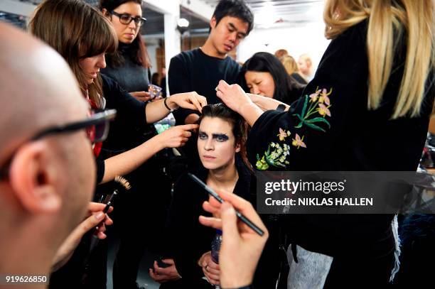 Model is prepared ahead of the catwalk show by British designer Gareth Pugh on the second day of London Fashion Week Autumn/Winter 2018 in London on...