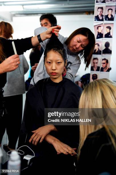 Stylists prepare a model backstage ahead of the catwalk show by British designer Gareth Pugh on the second day of London Fashion Week Autumn/Winter...