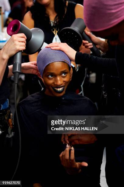 Stylists prepare a model backstage ahead of the catwalk show by British designer Gareth Pugh on the second day of London Fashion Week Autumn/Winter...
