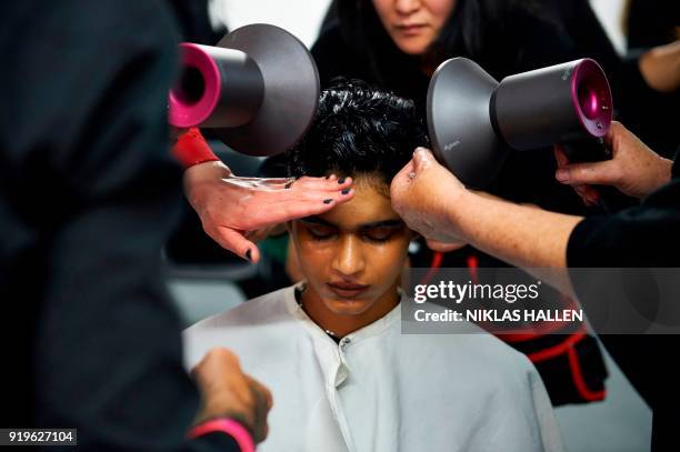 Stylists prepare a model backstage ahead of the catwalk show by British designer Gareth Pugh on the second day of London Fashion Week Autumn/Winter...