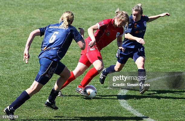 Georgia Chapman from Adelaide tries to get through a couple of Melbourne defenders during the round three W-League match between Adelaide United and...