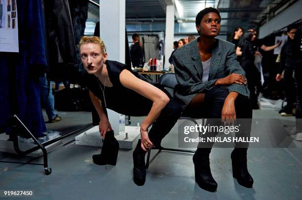 Models wait backstage ahead of the catwalk show by British designer Gareth Pugh on the second day of London Fashion Week Autumn/Winter 2018 in London...