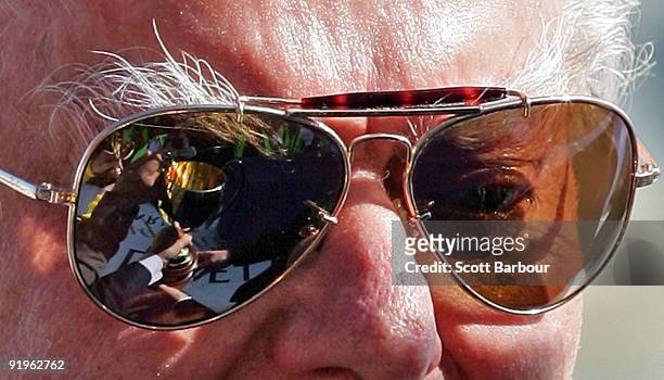 The Caulfield Cup is reflected in the glasses of the trainer of Viewed, Bart Cummings during the presentations for the Caulfield Cup during the...