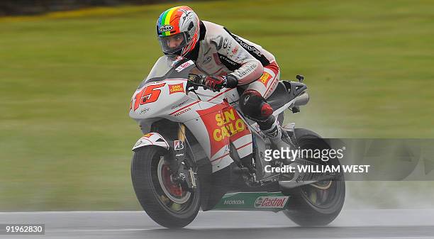Alex de Angelis of San Marino on a Honda speeds through a corner during practice for the Australian MotoGP Grand Prix at Phillip Island, some 100kms...