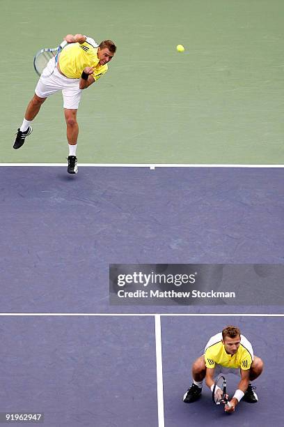 Marcin Matkowski of Poland serves to Julian Knowle and Jurgen Melzer of Austria while playing with Mariusz Fyrstenberg of Poland during day seven of...