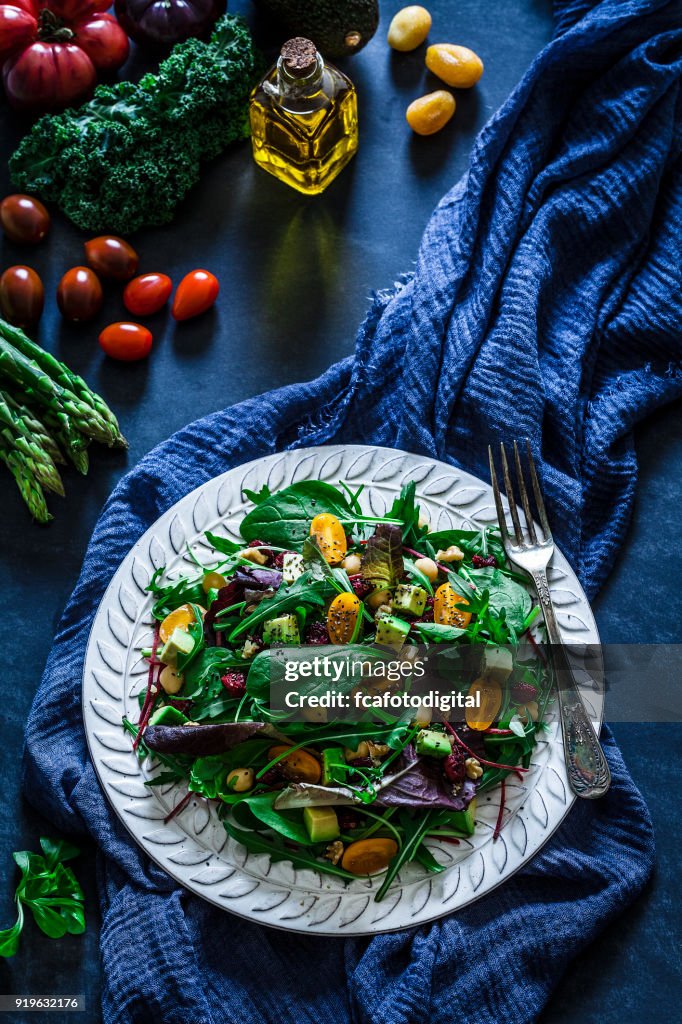 Healthy fresh salad plate on bluish tint table