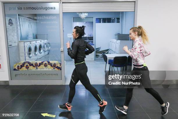 Runners running in front of launderette are seen in Gdansk, Poland on 17 February 2018 Runners take part in the Manhattan Run - run competition...