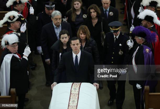 Grace Bauer and her mother, Erin Bauer, follow behind the casket of their father and husband, Chicago police Cmdr. Paul Bauer, during the recessional...