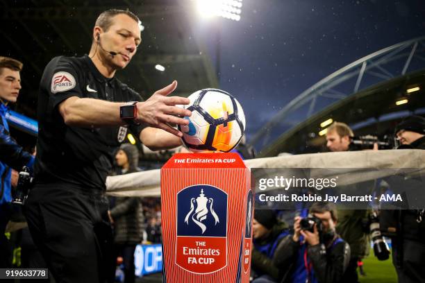 Referee Kevin Friend picks up the Emirates FA Cup match ball during the Emirates FA Cup Fifth Round match at The John Smiths Stadium on February 17,...