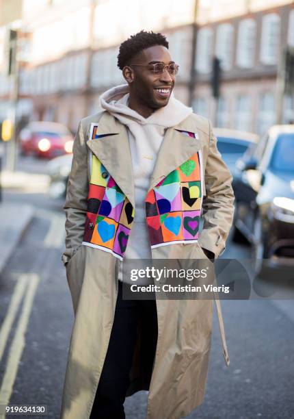 Rapper Tinie Tempah wearing beige JW Anderson trench coat, hoodie seen outside J.W. Anderson during London Fashion Week February 2018 on February 17,...