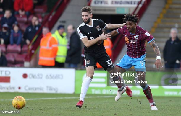 Ivan Toney of Scunthorpe United contests the ball with Jordan Turnbull of Northampton Town during the Sky Bet League One match between Scunthorpe...