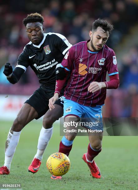 Gboly Ariyibi of Northampton Town and Levi Sutton of Scunthorpe United contest the ball during the Sky Bet League One match between Scunthorpe United...