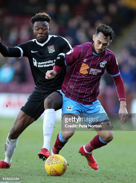 Gboly Ariyibi of Northampton Town and Levi Sutton of Scunthorpe United contest the ball during the Sky Bet League One match between Scunthorpe United...