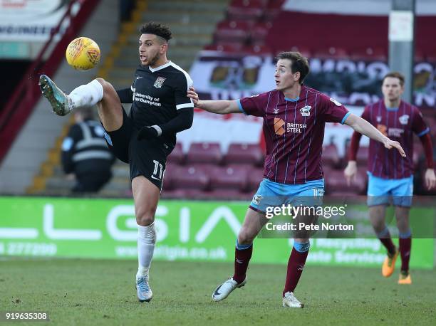 Daniel Powell of Northampton Town controls the ball as Josh Morris of Scunthorpe United looks on during the Sky Bet League One match between...