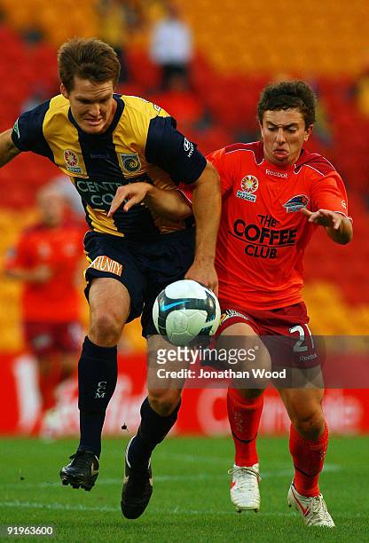 Ahmad Elrich of the Mariners and Tommy Oar of the Roar contest for the ball during the round 11 A-League match between the Brisbane Roar and the...