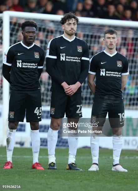Gboly Ariyibi, Matt Crooks and Chris Long of Northampton Town line up to defend a free kick during the Sky Bet League One match between Scunthorpe...