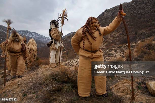 Revelers dressed as 'Harramachos' walk in the mountain during the traditional Navalacruz Carnival on February 17, 2018 in Navalacruz, Spain. The...