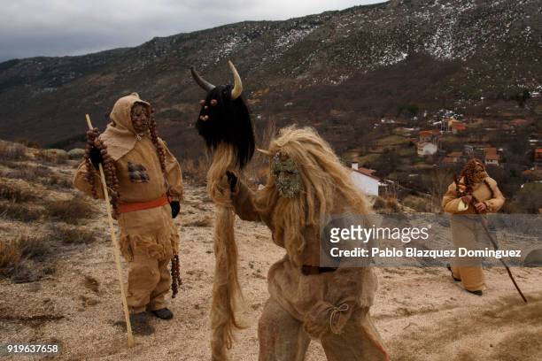 Revellers dressed as 'Harramachos' walk in the mountain during the traditional Navalacruz Carnival on February 17, 2018 in Navalacruz, Spain. The...