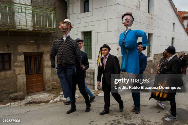 Revellers carry the Peleles that will burned at the end of traditional Navalacruz Carnival on February 17, 2018 in Navalacruz, Spain. The rural...