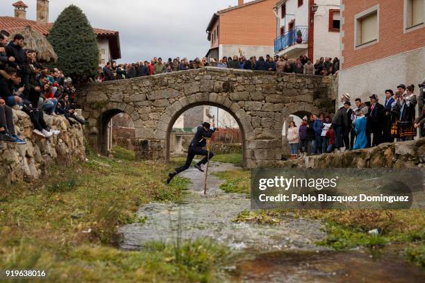 El Alcalde jumps the river with a pole during the traditional Navalacruz Carnival on February 17, 2018 in Navalacruz, Spain. The rural Navalacruz...