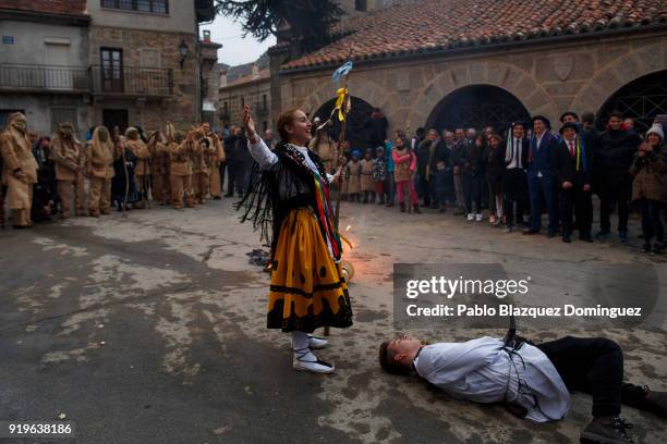 Woman wearing traditional costumes which symbolizes 'life' celebrates killing 'La Vaquilla' which symbolizes the 'devil' at the end of traditional...