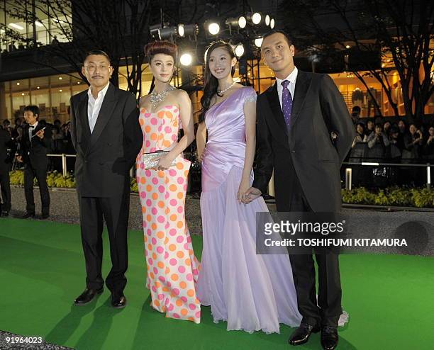 Chinese director He Ping poses with actresses, Fan Bingbing and Wang Jiajia , and actor Huang Jue while attending the opening green carpet event of...