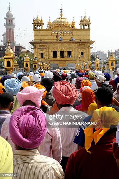 Indian Sikh devotees wait for their turn to pay respects inside the Golden Temple on the occasion of Bandi Chhor Divas or Diwali in Amritsar on...