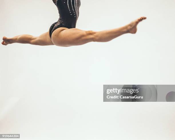 athlete doing a mid air split on white background - skill gap stock pictures, royalty-free photos & images
