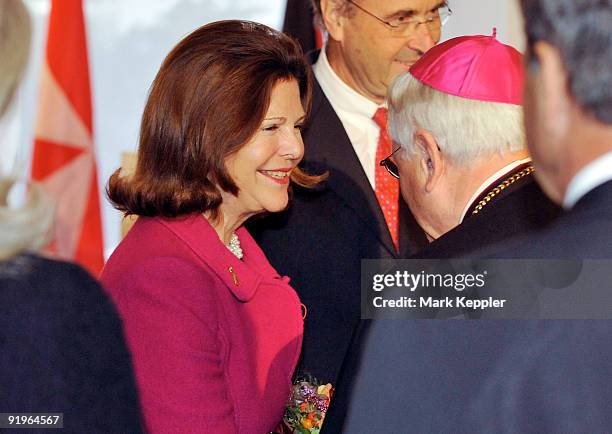 Queen Silvia of Sweden shakes hands with suffragan bishop Melzer prior to the opening of the first german section in a hospital for dementia patients...