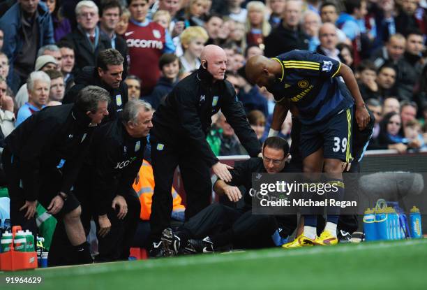 Martin O'Neill manager of Aston Villa is given assistance after colliding with Nicolas Anelka of Chelsea during the Barclays Premier League match...