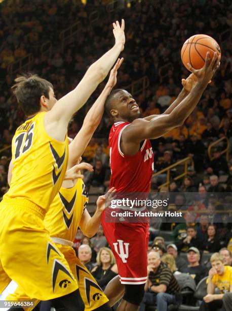 Guard Josh Newkirk of the Indiana Hoosiers goes to the basket during the second half against forward Ryan Kriener and guard Jordan Bohannon of the...