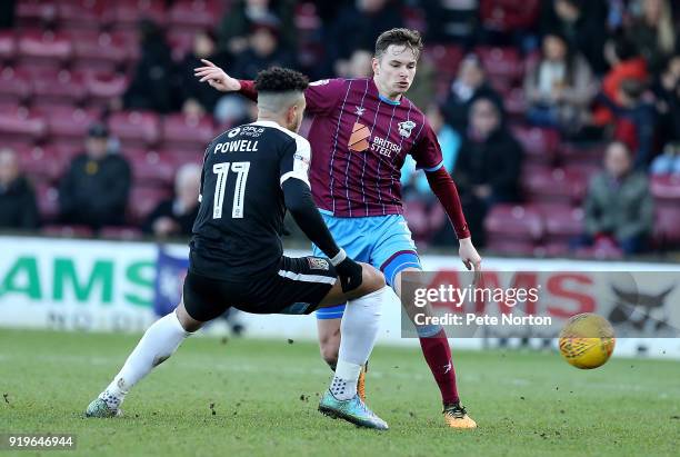 Conor Townsend of Scunthorpe United plays the ball past Daniel Powell of Northampton Town during the Sky Bet League One match between Scunthorpe...