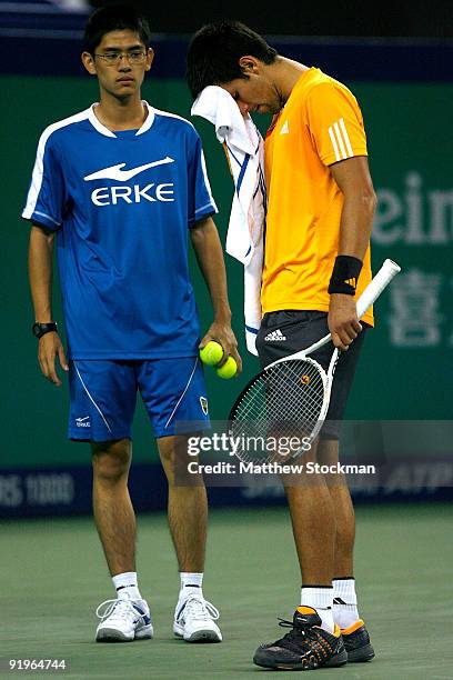 Novak Djokovic of Serbia pause will toweling off after loosing a long point to Nikolay Davydenko of Russia during the semifinal round on day seven of...