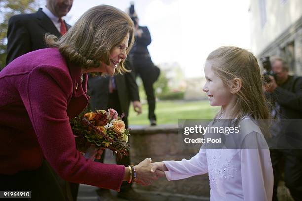 Queen Silvia of Sweden shakes hands with six-year-old Julia after opening of the first german section in a hospital for dementia patients following...