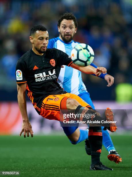 Manuel Rolando Iturra of Malaga CF duels for the ball with Francis Coquelin of Valencia CF during the La Liga match between Malaga and Valencia at...