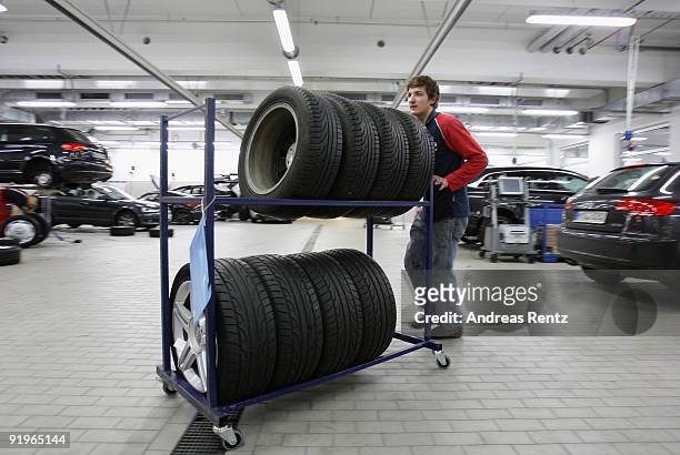 Mechanician pushes a tire cart at a Audi garage on October 17, 2009 in Berlin, Germany. German's prepare their cars for winter as cold temperatures...