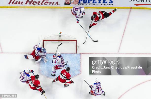 Thomas Chabot of the Ottawa Senators wraps around the net and banks the puck off of the skate of Nick Holden of the New York Rangers to score a goal...