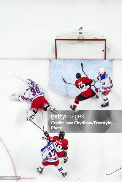 Henrik Lundqvist, Ryan Sproul and Jesper Fast of the New York Rangers and Marian Gaborik and Mike Hoffman of the Ottawa Senators watch the puck go...